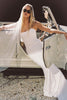 A woman wearing a strapless white mermaid style gown_XS_