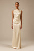 A woman modeling a sleeveless, floor-length cream satin gown with a draped, gathered bodice and skirt, set against a solid warm beige studio background_XS_