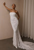 A woman wearing a strapless white lace wedding gown with a long train_XS_