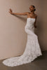 A woman wearing a strapless white lace wedding gown with a long train_XS_