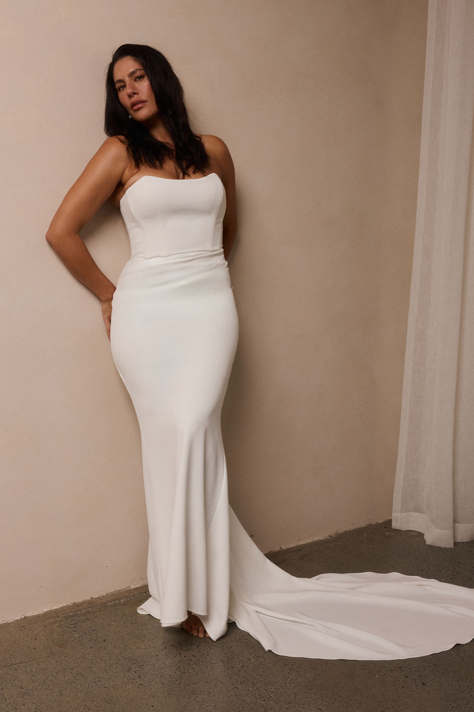 A woman wearing a strapless white mermaid style gown_L_