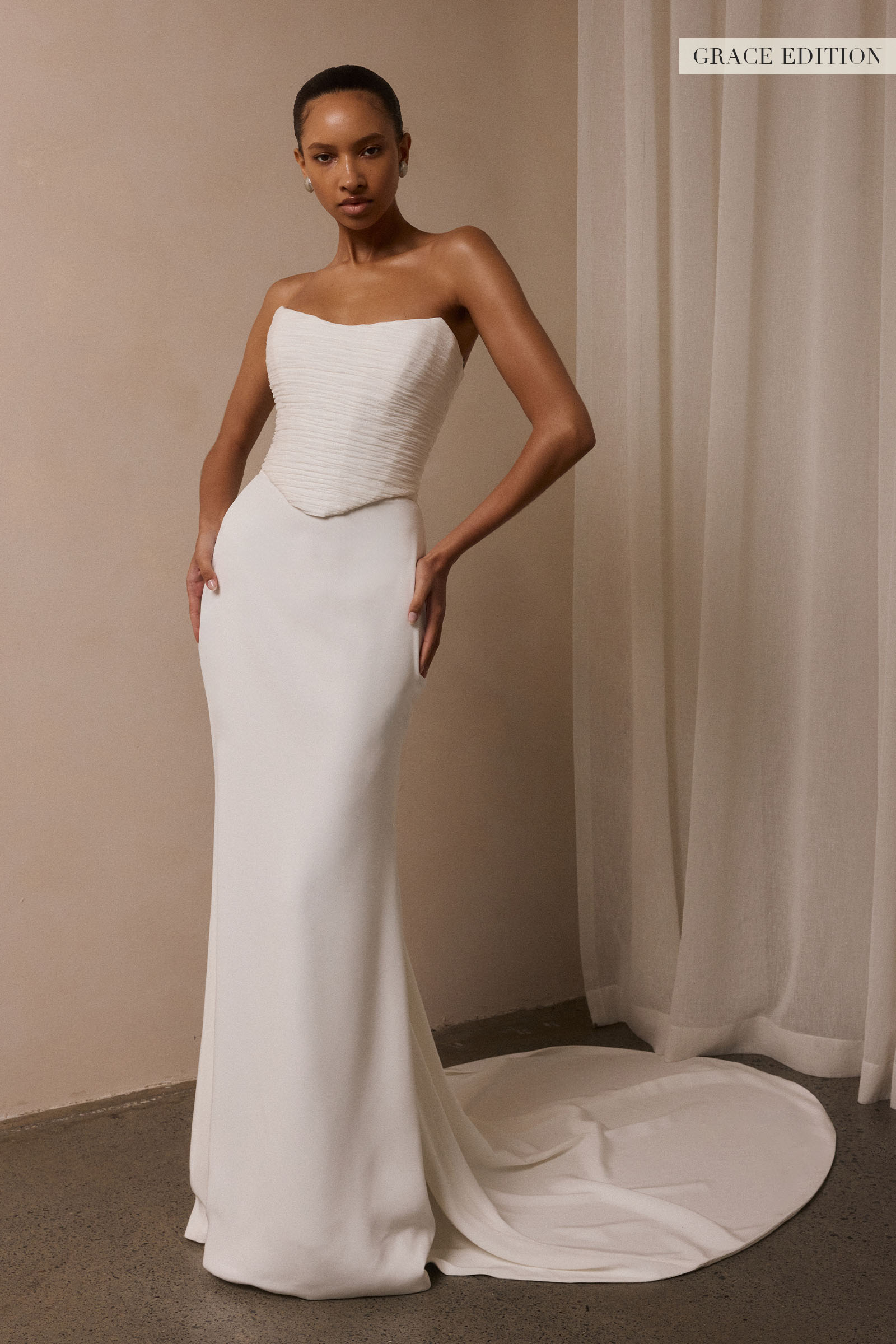 A woman models a structured corset and a long wedding skirt_XS_