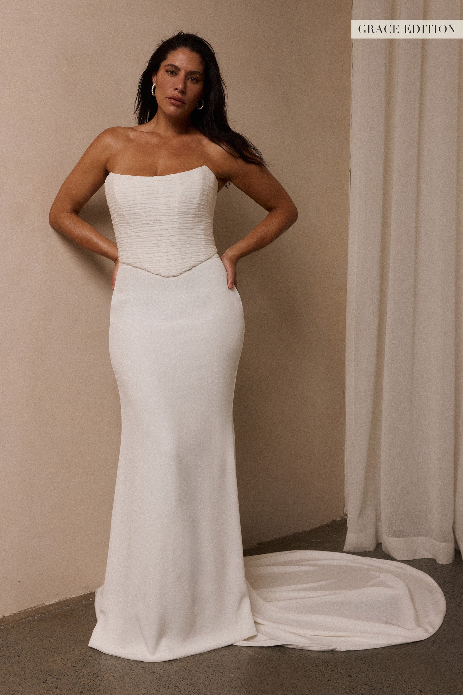 A woman models a structured corset and a long wedding skirt_L_