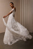 A woman wearing a white off-the-shoulder lace wedding gown with a deep V neckline and a full layered skirt_XS_