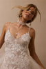 woman wearing a white lace backless dress with thin straps and delicate chain jewellery across her back_XS_