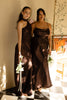 Two woman wearing brown bridesmaid dresses