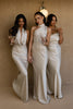 Women standing in champagne bridesmaid dresses