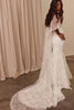 Woman wearing a white lace wedding dress with a Chantilly lace cape