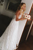 Woman in a lace wedding dress holding a cake_XS_
