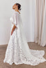 Woman wearing a lace wedding dress and bridal cape_L_