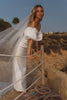 Woman in a satin wedding dress with a scenic background_XS_