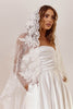 Woman wearing a strapless wedding dress with a lace veil_XS_