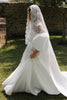 Woman wearing a satin wedding dress and lace mantilla veil_XS_