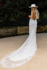 Woman in a backless lace wedding dress with a long train