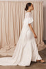 Woman in a wedding dress and sheer bridal cape
