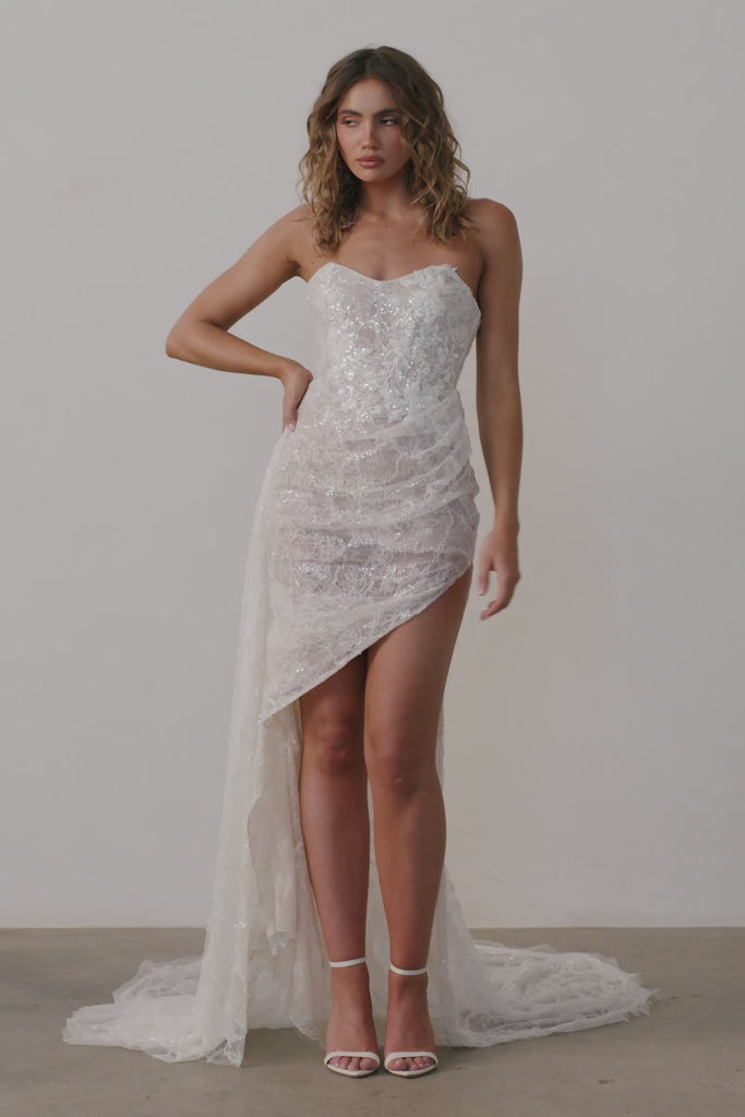 Woman wearing a strapless lace wedding dress.