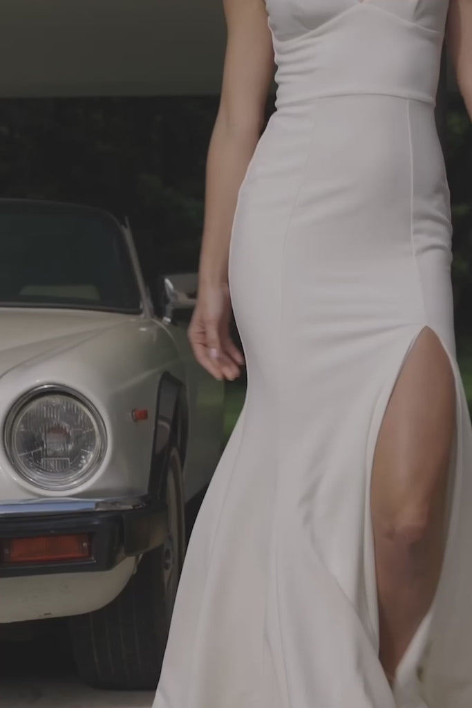 A woman wearing a crepe wedding dress.