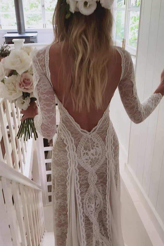Woman wearing a long sleeve boho wedding dress.